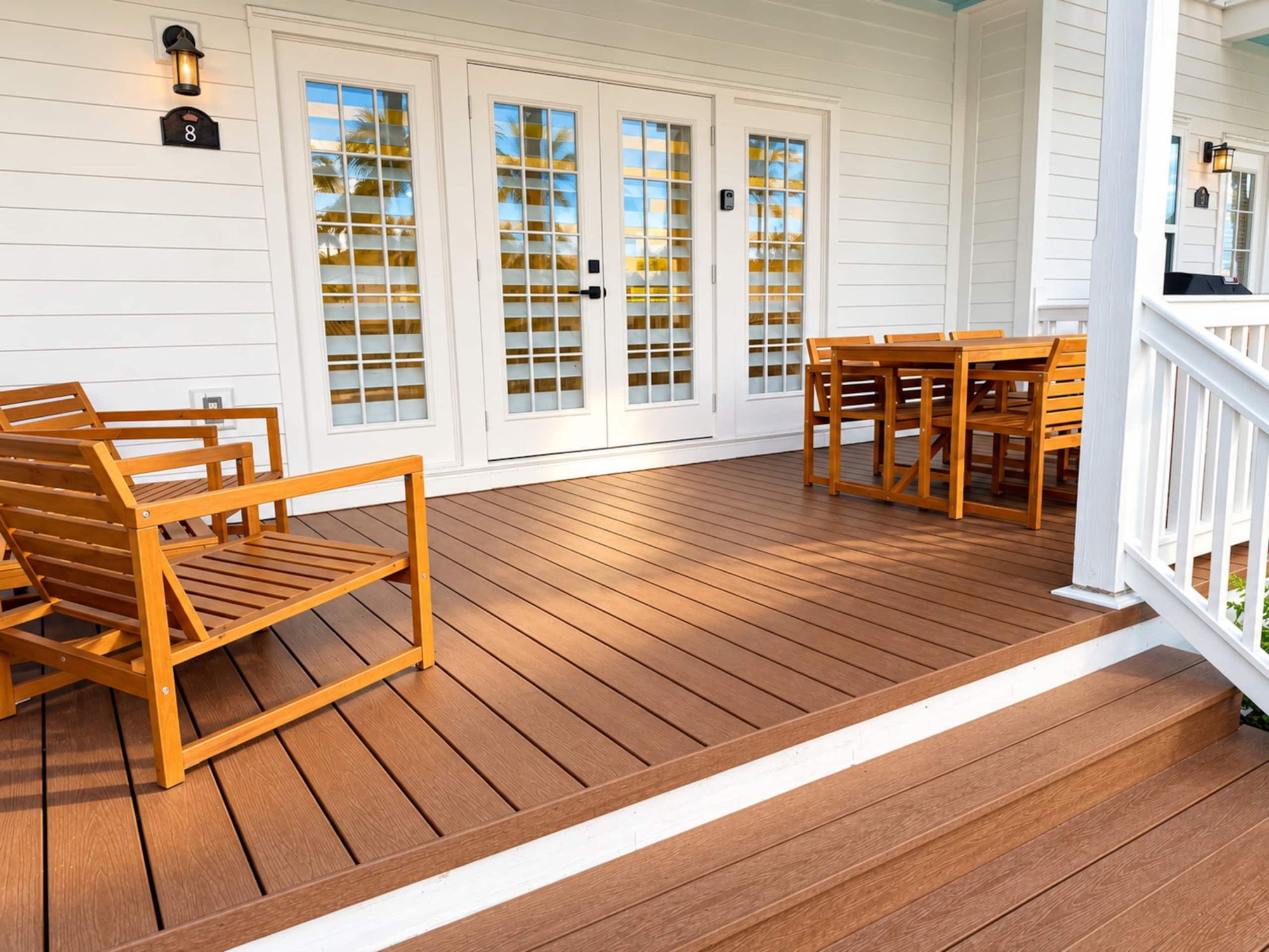 Covered waterfront terrace with loungers
